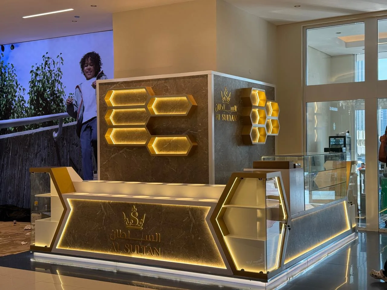 Al Sultan Honey kiosk at Lulu Mall Fujairah with backlit honeycomb branding and marble-effect counters
