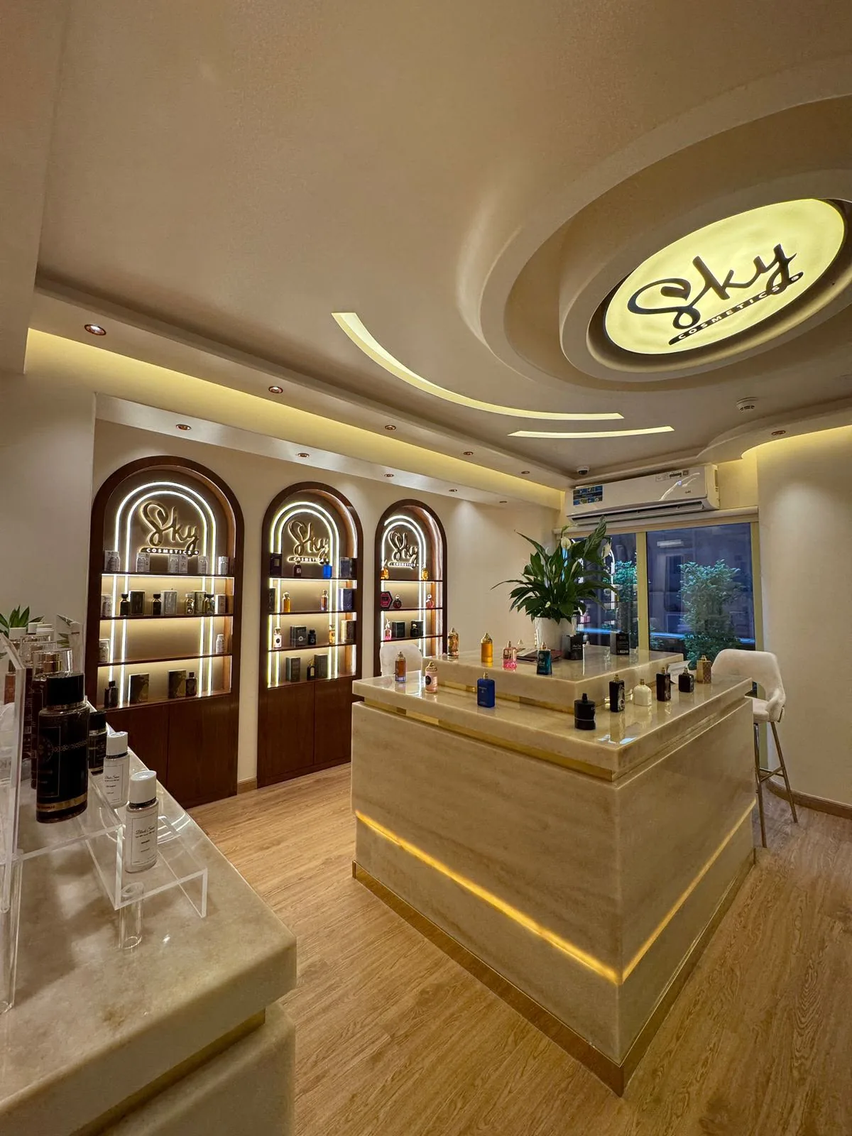 Sky Perfumes showroom with an illuminated oval ceiling feature and arched display alcoves
